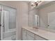 Bright bathroom with a large mirror, sleek vanity and a shower/tub combo at 112 Calder Dr, Alpharetta, GA 30009