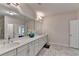 Bathroom boasting a long vanity with double sinks, modern fixtures, and an open doorway at 112 Calder Dr, Alpharetta, GA 30009