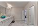 Bathroom showing white marble tile floors, double vanity, and access to closet at 112 Calder Dr, Alpharetta, GA 30009