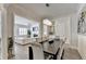 Open-concept dining room with hardwood floors, chandelier, and view of the living room at 112 Calder Dr, Alpharetta, GA 30009