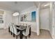 Bright dining room featuring a large table with seating for eight and modern chandelier lighting at 112 Calder Dr, Alpharetta, GA 30009