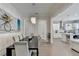 Elegant dining area with view to the kitchen and seating for eight at 112 Calder Dr, Alpharetta, GA 30009