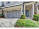 Charming brick home features a garage, covered entry and a blue front door at 112 Calder Dr, Alpharetta, GA 30009