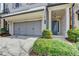 Welcoming facade with a two-car garage and covered entry framed by white columns at 112 Calder Dr, Alpharetta, GA 30009