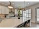 Eat-in kitchen island with marble countertops, modern lighting, and stainless appliances at 112 Calder Dr, Alpharetta, GA 30009