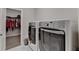 Bright laundry room with modern, front-load washer and dryer, with a walk-in closet at 112 Calder Dr, Alpharetta, GA 30009