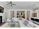 Spacious living room with a fireplace and views into the dining area and open kitchen at 112 Calder Dr, Alpharetta, GA 30009
