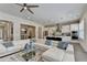An open living room with hardwood floors, large sofa, modern lighting and views into the kitchen at 112 Calder Dr, Alpharetta, GA 30009