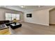 Bright and airy living room boasts hardwood floors, large window, and television at 112 Calder Dr, Alpharetta, GA 30009