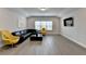 Spacious living room with hardwood floors, large window, black leather sofa and television at 112 Calder Dr, Alpharetta, GA 30009