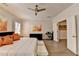 A spacious main bedroom with hardwood floors, a ceiling fan, a piano, and access to an office at 112 Calder Dr, Alpharetta, GA 30009