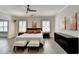 A spacious main bedroom featuring hardwood floors, a ceiling fan, two bedside tables, and a dresser at 112 Calder Dr, Alpharetta, GA 30009
