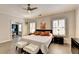 A spacious main bedroom featuring hardwood floors, a ceiling fan, and access to an office at 112 Calder Dr, Alpharetta, GA 30009