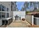 An outdoor kitchen on a brick patio with a grill, table, and accent fire pit at 112 Calder Dr, Alpharetta, GA 30009