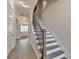 Hallway staircase with hardwood floors and modern black railings at 112 Calder Dr, Alpharetta, GA 30009