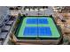 Aerial view of pristine tennis courts with green and blue surfaces, perfect for sports enthusiasts at 112 Calder Dr, Alpharetta, GA 30009