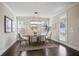 Formal dining room with modern light fixture, wood floors, and access to the outdoor area at 2471 Arnold Palmer Way, Duluth, GA 30096