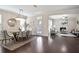 View of dining area and living room, featuring fireplace, modern furniture, and hardwood flooring at 2471 Arnold Palmer Way, Duluth, GA 30096