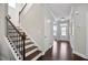 Inviting home entry featuring hardwood floors and a staircase with dark wood railing at 2471 Arnold Palmer Way, Duluth, GA 30096