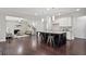 Open kitchen view to living room with fireplace, island with seating, and hardwood flooring at 2471 Arnold Palmer Way, Duluth, GA 30096