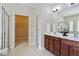 Main bathroom with double sinks, walk-in shower, and view to the walk-in closet at 2471 Arnold Palmer Way, Duluth, GA 30096