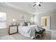 Main bedroom features a tray ceiling, natural light, and ensuite bathroom at 2471 Arnold Palmer Way, Duluth, GA 30096