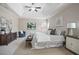 This main bedroom features a tray ceiling, ceiling fan, and a light colored rug at 2471 Arnold Palmer Way, Duluth, GA 30096