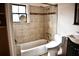 This bathroom features a shower over the tub and neutral tile at 2642 Joyce Ave, Decatur, GA 30032