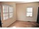 Neutral bedroom with plenty of natural light, hardwood floors and 2 windows at 2642 Joyce Ave, Decatur, GA 30032