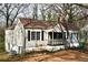 Charming single-Gathering home featuring a quaint front porch and a well-maintained lawn surrounded by mature trees at 2642 Joyce Ave, Decatur, GA 30032