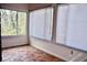 Enclosed sunroom filled with natural light through large windows and terracotta tile flooring at 2642 Joyce Ave, Decatur, GA 30032