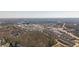 Distant aerial view of mixed-use neighborhood, retail and business district surrounded by lush green spaces at 385 Rowes Cir, Alpharetta, GA 30009