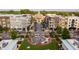 Aerial view featuring a town square with a park, shops, and a water feature surrounded by buildings at 385 Rowes Cir, Alpharetta, GA 30009