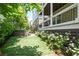 Backyard features a manicured lawn and a relaxing hot tub underneath a covered patio at 385 Rowes Cir, Alpharetta, GA 30009