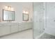 Bright, modern bathroom featuring double sinks, a walk-in shower with glass door, and elegant finishes at 385 Rowes Cir, Alpharetta, GA 30009