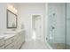 Clean bathroom featuring dual vanities, stone floors, and a glass-enclosed shower at 385 Rowes Cir, Alpharetta, GA 30009