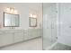 Bright bathroom with dual vanities, large mirrors, and a glass-enclosed shower at 385 Rowes Cir, Alpharetta, GA 30009
