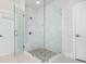 Bathroom features a spacious shower with glass enclosure, marble tiling, and a built-in bench at 385 Rowes Cir, Alpharetta, GA 30009