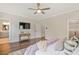 Spacious bedroom featuring hardwood floors, TV, and ensuite bathroom at 385 Rowes Cir, Alpharetta, GA 30009