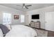 Serene bedroom featuring a dresser with TV, a large bed, and ample natural light, perfect for relaxation at 385 Rowes Cir, Alpharetta, GA 30009