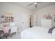 Inviting bedroom with a charming desk setup, white furniture, and a view into an attached bathroom at 385 Rowes Cir, Alpharetta, GA 30009