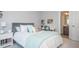Charming bedroom with a cozy bed, a tidy desk area, and a glimpse into the adjacent bathroom at 385 Rowes Cir, Alpharetta, GA 30009