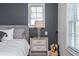 Bedroom detail showcasing a nightstand with lamp, next to a bed, with an acoustic guitar at 385 Rowes Cir, Alpharetta, GA 30009