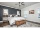 Comfortable bedroom featuring a king-size bed, stylish furnishings, and ample natural light from the windows at 385 Rowes Cir, Alpharetta, GA 30009