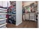 Organized walk-in closet featuring custom shelving, hanging rods, and hardwood floors at 385 Rowes Cir, Alpharetta, GA 30009