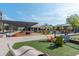 Community green space with colorful Adirondack chairs, turf, a dog park, and lounge seating for relaxing at 385 Rowes Cir, Alpharetta, GA 30009