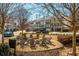 Community outdoor firepit surrounded by chairs with several houses in the background at 385 Rowes Cir, Alpharetta, GA 30009