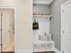 Mudroom entryway featuring a built-in bench with storage, coat hooks, and access to the bathroom at 385 Rowes Cir, Alpharetta, GA 30009