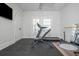 Bright exercise room featuring a treadmill, weight bench, and barre set against light walls and rubber mat flooring at 385 Rowes Cir, Alpharetta, GA 30009