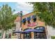 View of the Nauti Dog restaurant exterior with blue awnings, signage, and outdoor seating under blue umbrellas at 385 Rowes Cir, Alpharetta, GA 30009